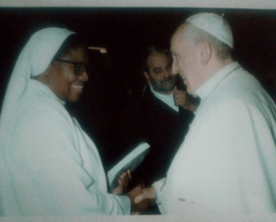 Pope Francis receives the biography from Mother Leonie-Martha O’Karaga, HHCJ