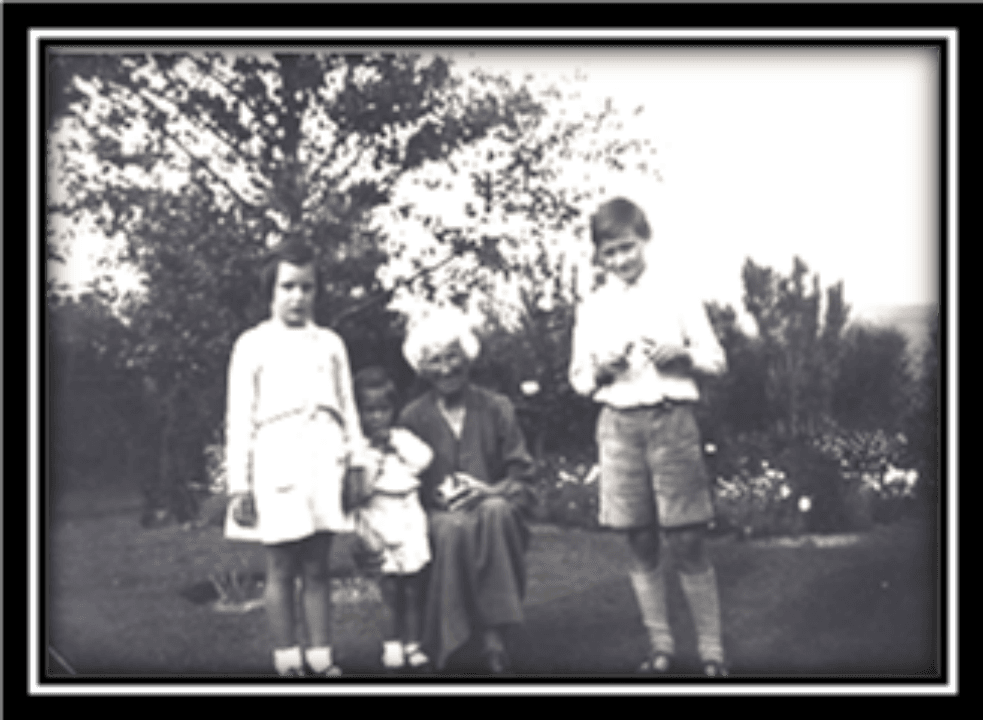Mother Walker (Miss Walker) in her garden with neighborhood children